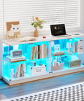 Glass Display Cabinet With Charging Station And RGB Lighting 59 Inch in a modern living room with collectibles and tech on display