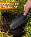 Hand holding a black trowel digging soil with Workhorse Heavy Duty Sand Scoop For Metal Detecting With Shovel And Trowel Beach Sand Sifter.