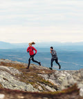 Two trail runners on rocky mountain terrain wearing a Durable Mountain Rescue Belt With Two Integrated Rescue Reflectors Flexible Nylon Strap And Sturdy Metal Buckle Boost Your Backcountry Gear Visibility To Help Over 950 Pros.