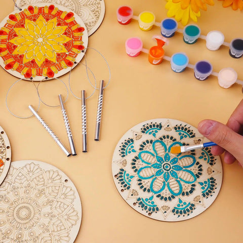 DIY Mandala Wind Chimes Craft Kit for Kids Color Your Own Wind Chimes With Wood Hanging Ornaments 24 Sets Kid Friendly Fun Craft Project For Home School Party Activity showing painting process with brushes and colors.