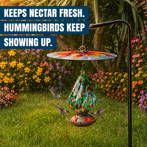 Top Shelf Bird Feeder Baffle And Rain Guard Dome Cover, Ironclad Weatherproof Shield To Keep Squirrels Out And Seed Dry, No Hassle Steel Mount Kit In Bold Red Floral Design hanging above colorful garden.