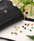 Assorted metal cone spike studs with screw back including 50 Sets Cone Spike Stud Rivets With Screw Back 8x12mm M3x0.5 Thread Orange Punk Hardware beside a black leather bag.