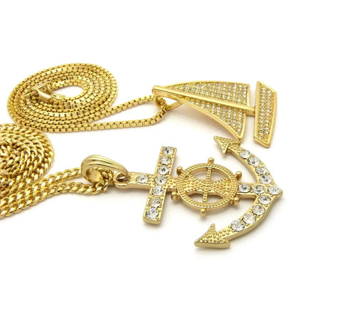 Dope Iced Out Sailboat Yacht And Anchor Pendant Necklace Set In Gold Tone With Two Necklace Set And Layered Chains Including 20 Inch Box Chain And 24 Inch Cuban Chain Plus 30 Inch Long Option For Maximum Bling showing close-up of anchor and sailboat pendants