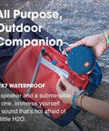 Person holding Clip 3 Fiesta Red Portable Bluetooth Speaker With Up To 10 Hours Of Playtime, Waterproof And Durable