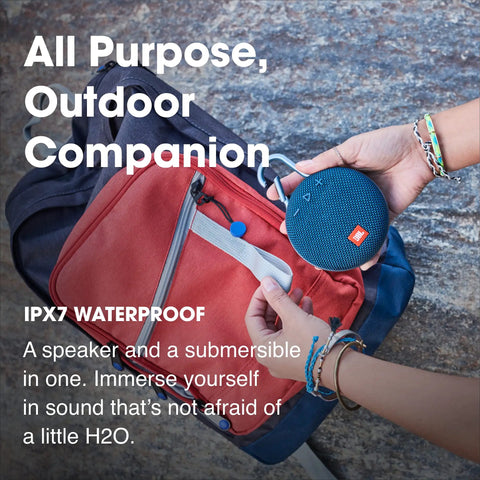 Person holding Clip 3 Fiesta Red Portable Bluetooth Speaker With Up To 10 Hours Of Playtime, Waterproof And Durable