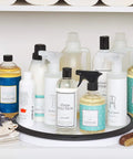 Huge 16 Inch Lazy Susan Turntable With Soft Non Slip Lip And Deep Ledge holding cleaning products in a cabinet