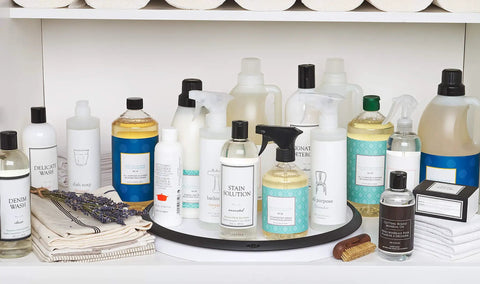Huge 16 Inch Lazy Susan Turntable With Soft Non Slip Lip And Deep Ledge holding cleaning products in a cabinet