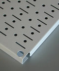 Corner view of Heavy Duty Galvanized Steel Pegboard Panel 32 Inch By 16 Inch Tool Board for garage with rust-resistant finish.