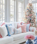 Living room with decorated Christmas tree, white couch, Coastal Chic 20x20 Throw Pillow Cover With Scalloped Border in blush pink.