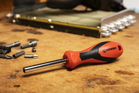 Quarter Inch Drive Dual Material Bit Holding Screwdriver Handle with ergonomic balance, chrome shank on a workbench