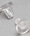 Close-up of clear vinyl pads stem bumpers, part of Ten Pack Glass Table Top Bumpers Clear Vinyl Pads Spacers For Patio Furniture Indoor Outdoor With Strong Grip Prevents Sliding Fits A Quarter Inch Hole Stem Bumpers Base Half Inch Diameter One Eighth Inch Thick.