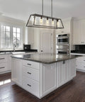 Oil Rubbed Bronze 38 Inch 5-Light Farmhouse Linear Pendant For Kitchen Island hanging over modern kitchen island with white cabinets.