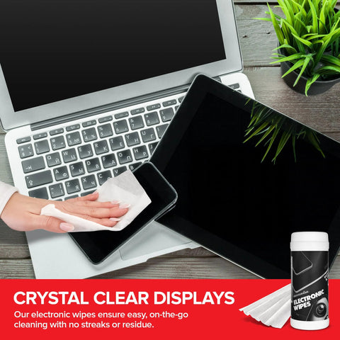 Top-down view of electronic screen cleaner wipes bottle with white cap on desk beside laptop and tablet