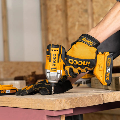Person using 20V Cordless Brushless Impact Driver Set With 1/4 Inch Drive on wood; includes dual batteries and carry bag.