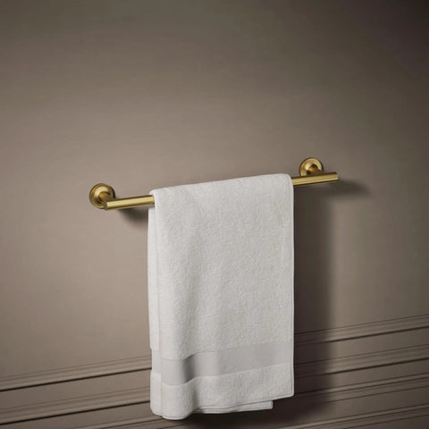 Purist 18-Inch Towel Bar in Vibrant Brushed Moderne Brass Dope Finish mounted on wall with white towel