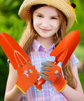 Child holding orange shovels and gloves from 24 Piece Kid Friendly Garden Tool Set With Mini Colorful Metal Shovels And Gloves Includes 12 Hand Trowels In 6 Colors And 12 Pairs Of Garden Gloves Ideal For Little Gardeners 11 By 3 Inch Shovels.