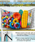 Big Pool Float Storage Net With 20 Hooks And Storage Bag hanging on fence filled with colorful floats, rings, and inflatables
