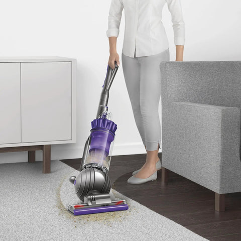 Person using Ball Animal Origin Upright Vacuum For Pet Hair And Allergies, Pro Grade Suction With Ball Steering in purple on carpet