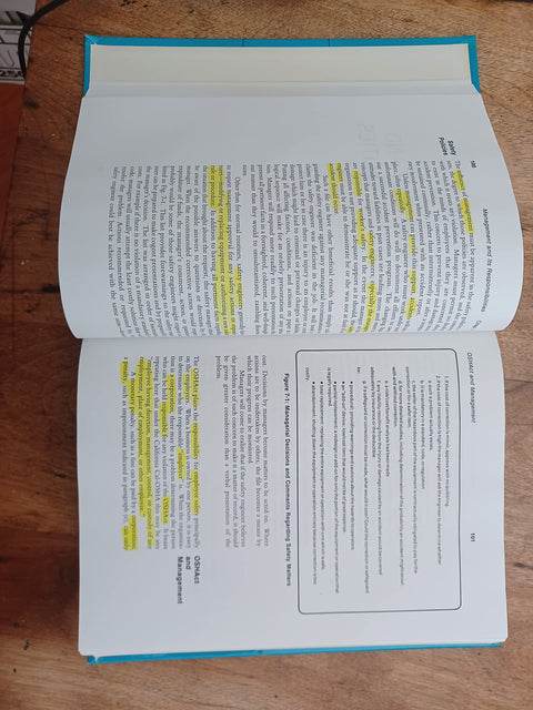 Book: Occupational Safety Management and Engineering, Amazon, blue cover, open pages with highlighted text.