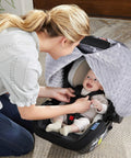 Mother interacting with baby under All In One Baby Car Seat Cover And Nursing Shield With 360 Degree Full Coverage Peekaboo Opening