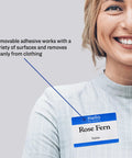 Smiling person wearing customizable Hello My Name Is name tag white with blue border removable adhesive for laser and inkjet printing