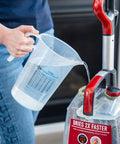 Person pouring water from 64oz Half Gallon Measure Pitcher With Conversion Chart Heavy Duty Food Grade Polypropylene BPA Free Stain Resistant Translucent For Easy View Of Contents Dishwasher Safe Microwave Safe Great For Lawn Pool Spa Agriculture Home Hobbies Lye Cooking into a steam cleaner.