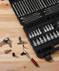 Open case showing Beefy 107-Piece Bit Socket Set With 1/4-Inch, 3/8-Inch, And 1/2-Inch Drives, SAE and Metric bits on wooden surface.