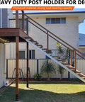 Installed heavy duty post holder supporting elevated deck with stairs, showcasing thickened material and load-bearing capacity.