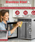 Woman cleaning Boss Level 12-Tray Stainless Steel Food Dehydrator With Dishwasher Safe Trays And 800W Digital Panel.