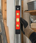Hand holding a spirit level against a metal pole, featuring three bubble vials, New Yellow Level 23CM.