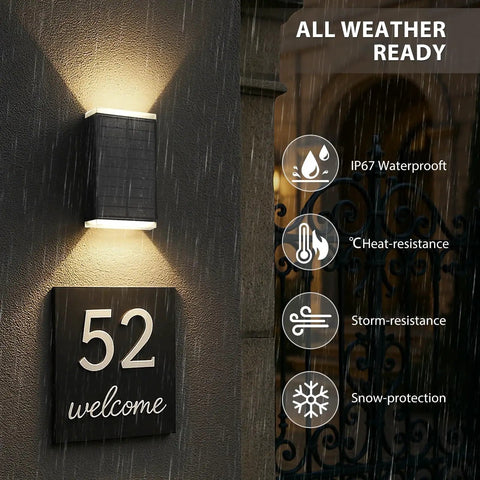 Hella Bright Solar Wall Light Outdoor Featuring Slick Up And Down Lighting above a welcome sign on a rainy wall.