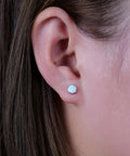 Solid Implant Grade Titanium Screw Back Earrings Made For Sensitive Skin With Hypoallergenic F136 Studs That Stay Put And Keep Your Jewelry Low Drama Always, worn in ear with white opal stone.