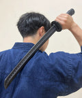 Person holding Polypropylene Short Katana Black Sword With Black Scabbard 23.5 Inch Overall Length 16 Inch Blade over shoulder