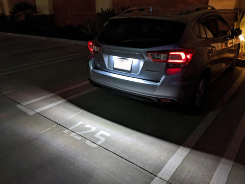 Car with OEM-Fit 3W Full LED License Plate Light Kit Direct Fit For Scion FR-S Toyota 86 Subaru BRZ Impreza WRX STI Legacy Crosstrek Ascent With 24-SMD Xenon White LEDs illuminating parking spot.