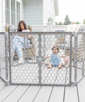 Woman and baby interacting outside using Mega Wide 192 Inch Baby Gate And Play Yard 2 In 1 Gate To Playpen Gray on patio.