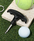 Adjustable Golf Wrench Tool For Driver Heads, Stainless Steel, Plastic Handle, shown on grassy surface near balls