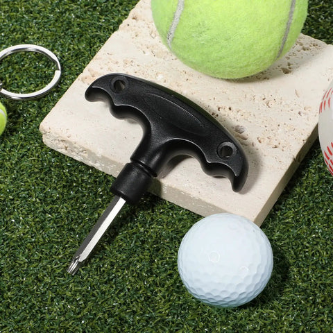 Adjustable Golf Wrench Tool For Driver Heads, Stainless Steel, Plastic Handle, shown on grassy surface near balls