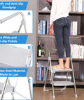 Two Step Stainless Steel Folding Ladder With 500 Pound Capacity Wide Anti Slip Pedals And Beefy Durable Handgrip in use in a library