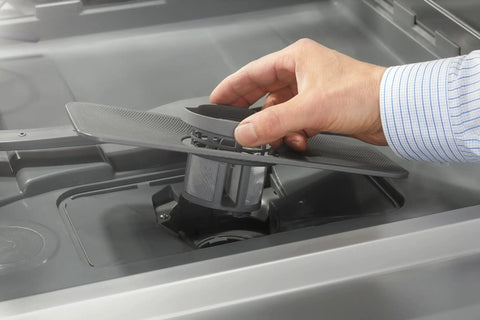 Total Game Changer Compact Countertop Dishwasher In Brushed Stainless Steel showing a hand adjusting the spray arm inside.