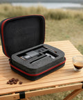 Slick Waterproof Coffee Grinder Travel Case with heavy duty grab handle, opened, showing shockproof foam lining and coffee.