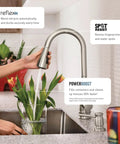 Top Shelf Stainless Steel Pull Down Kitchen Faucet Featuring One Handle High Arc Design With Fast Wash Power Boost And Smudge Resistant Matte Finish For Quick Cleanup And No Hassle Setup Plus Smooth Retractable Spray Hose Operation in use with flowers in kitchen.