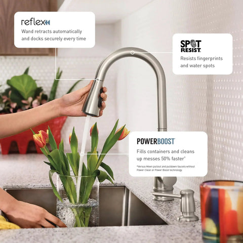 Top Shelf Stainless Steel Pull Down Kitchen Faucet Featuring One Handle High Arc Design With Fast Wash Power Boost And Smudge Resistant Matte Finish For Quick Cleanup And No Hassle Setup Plus Smooth Retractable Spray Hose Operation in use with flowers in kitchen.