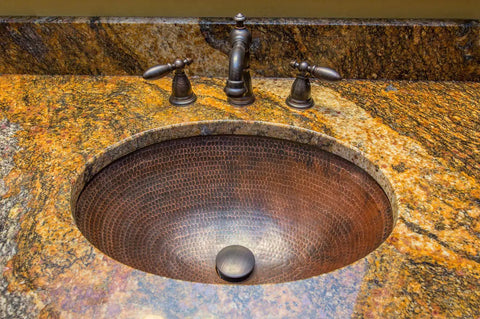 Oil Rubbed Bronze 1.5 Inch Non Overflow Pop Up Bathroom Sink Drain With Push Pop Top Design in a granite vanity setup