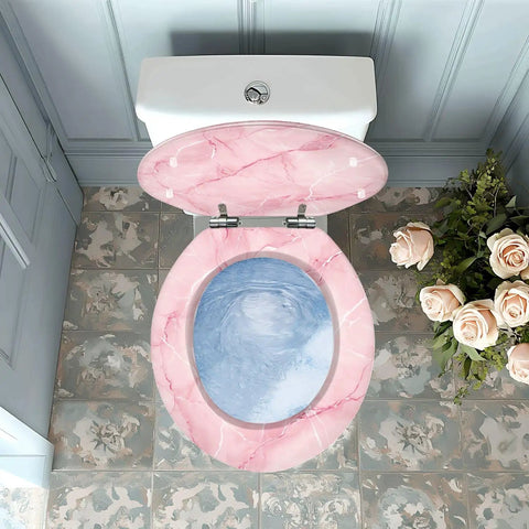 Toilet Seat Round Resin for Bathroom in pink marble design with blue water effect, fitted on toilet bowl from above view.