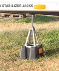 Beefy Heavy Duty RV Stabilizer Jacks, 7,900 Lbs Capacity installed under RV, showing durable aluminum design on grass.