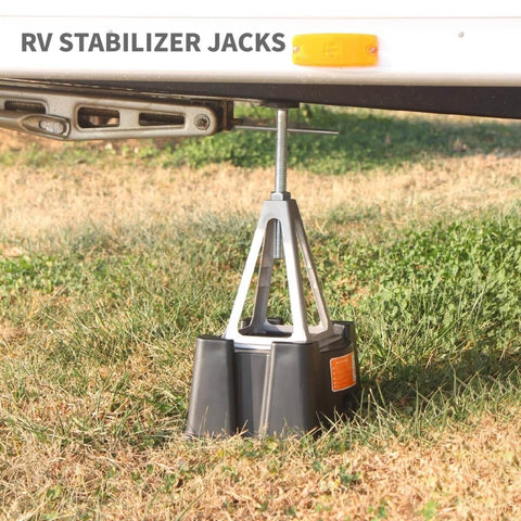Beefy Heavy Duty RV Stabilizer Jacks, 7,900 Lbs Capacity installed under RV, showing durable aluminum design on grass.
