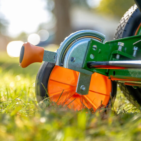 Close-up of Dual Tracking Wheels on a Manual 20-Inch 5-Blade Push Reel Lawn Mower With Ball Bearing Reel, Green Finish