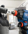 Worker using Two-In-One 18V Impact Driver Kit With 1/4 Inch Quick-Change Hex And 1/2 Inch Drive, Delivers Up To 1,600 In-Lbs Torque.