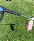 SG28 Spray Gun With Easy Hold Tech For Pressure Washers in action, held outdoors, showing trigger and nozzle attachment.