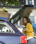 Woman packing car with Rear Hatch Lift Supports For Suburban Tahoe Yukon SUVs 07-14 Left And Right Gas Springs visible